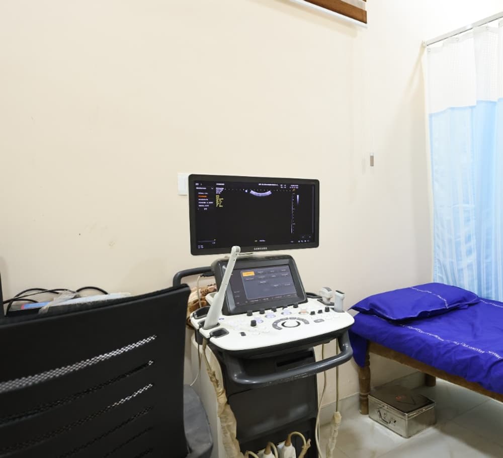 An ultrasound room with the scanner, monitor and examination couch